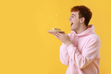 Poster - Young man with piece of birthday cake on yellow background