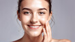 © Art - Woman smiling while touching her flawless glowy skin with copy space for your advertisement, skincare