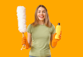 Sticker - Young woman with bottle of detergent and pp-duster on orange background