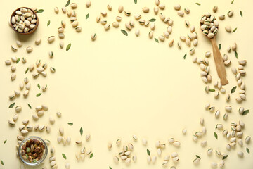 Wall Mural - Frame made of bowls and wooden spoon with tasty pistachio nuts on yellow background