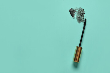 Wall Mural - Black mascara brush with sample on turquoise background