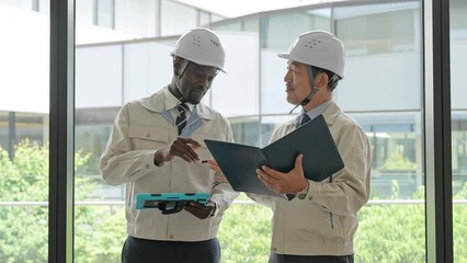 Poster - Group of multinational engineers having a conversation in a building