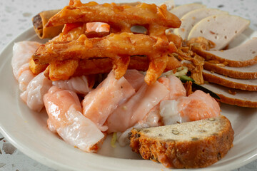 A closeup view of a plate of banh cuon tom.