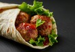 © Balaraw - Tasty meatball wrap with fresh lettuce
