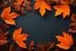 © Anna - autumn design concept made of orange maple and oak leaves on a dark background. Flat layout, top view with space to copy