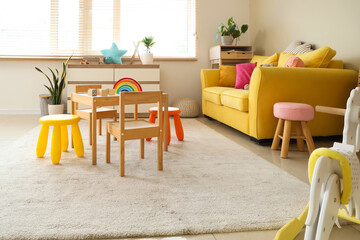 Poster - Interior of modern playroom with toys and rocking horse in kindergarten