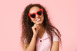 © Pixel-Shot - Happy young African-American woman in sunglasses on pink background