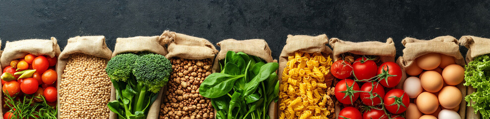 Healthy food. Variety of vegetables, fruits, herbs, cereals and legumes on a texture table. View from above. Place for text. Balanced diet. Banner