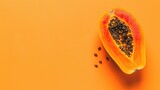 A whole papaya on a light orange background, web banner with copy space for text.