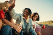 © Jacob Lund - Happy young friends enjoying outdoor gathering with drinks and laughter