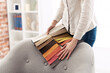 © StockPhotoPro - Professional decorator choosing the best upholstery for the armchair