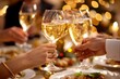 © Elmira - Close-up shot of three people toasting with champagne during a holiday dinner celebration at a restaurant