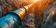 © Lidok_L - A long pipe is shown in the dirt, with the sun shining on it