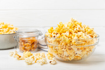 Wall Mural - Tasty popcorn on woodenbackground. Cinema and entertainment concept. Movie night with popcorn.Cheese and caramel popcorn. Delicious appetizer, snack. Place for text. Copy space.Banner