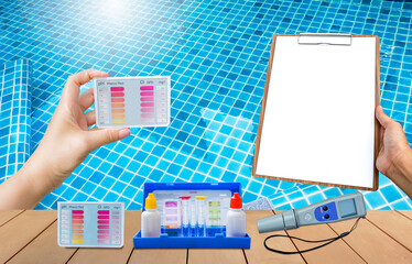 Wall Mural - Water tester on wooden floor with clipboard in girl hand over clear swimming pool water background, quality water tester equipment