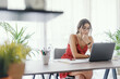 © StockPhotoPro - Student sitting at desk and working with a laptop
