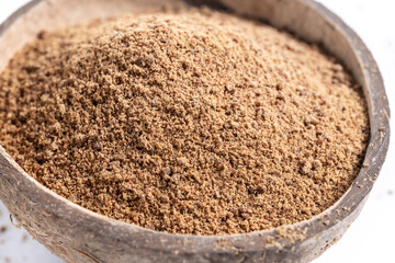 Wall Mural - Coconut palm sugar in coconut bowl isolated on white background. Close up