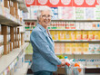 © StockPhotoPro - Confident senior woman doing grocery shopping at the supermarket