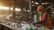 © mongkonchai - Workers wearing orange vests and orange hard hats sort plastic waste onto a conveyor belt in a waste separation factory.