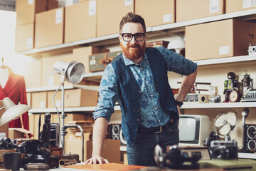 Wall Mural - Young confident business owner posing in his shop