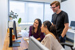 © Austockphoto - Three designers looking at the computer in an office