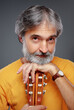 © luengo_ua - Aged bearded man with an acoustic guitar