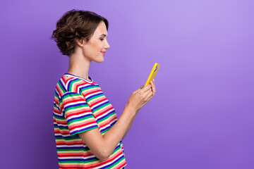 Poster - Profile portrait of pretty positive lady use smart phone texting empty space isolated on purple color background