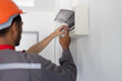 © Wasan - Two electricians are repairing electricity in a house.