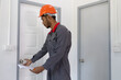 © Wasan - Home repairman opening a doorknob with a key.