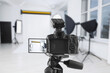 © New Africa - Professional camera on tripod in photo studio