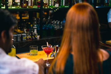 Wall Mural - Caucasian man and woman dating and hanging out drinking alcoholic cocktail on holiday event at luxury restaurant bar. Cheerful people enjoy and fun meeting nightlife celebration party at nightclub.