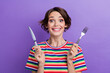 © deagreez - Photo of cheerful glad girl wear stylish clothes hands holding cutlery waiting her tasty lunch isolated on purple color background
