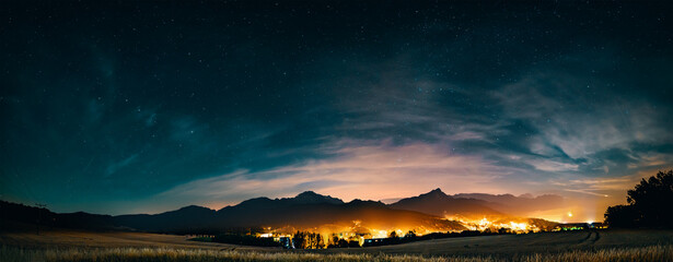 Canvas Print - night city Starry sky and mountains on the horizon