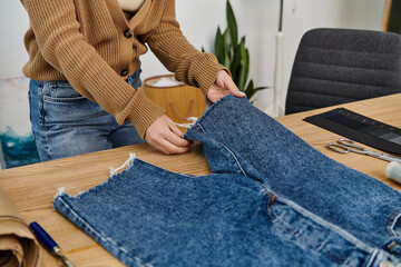 Wall Mural - A woman creatively upcycles denim jeans.