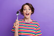© deagreez - Photo of cheerful glad girl dressed stylish striped clothes hold spoon want eat delicious dessert isolated on purple color background