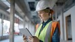 © pkproject - Female Construction Worker Utilizing Tablet at Modern Building Site