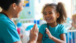 © XaMaps - A pediatric nurse playing a hand-clapping game with a smiling child in a hospital ward, creating a joyful atmosphere.