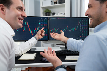Wall Mural - Successful stock exchange traders focusing on high profit chart investment on dynamic database, analyzing on monitor. Concept of discussing financial technology growth at workplace. Sellable.