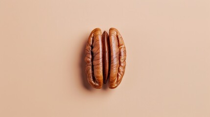 Wall Mural - Close-up of pecan nuts on a beige background, minimalistic food photography concept