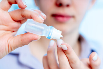 Canvas Print - young woman dripping a medical drop on her finger