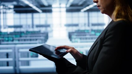 Poster - system administrator monitoring server room, doing checkup, inputting data on tablet of needed fixes
