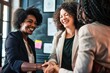 © ORG - Smiling businesswoman shaking hands with customer in office meeting