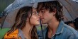 © Ihor - A couple shares a passionate kiss in the rain, standing close under an umbrella