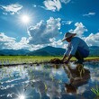 © Surachetsh - rhythm of rural life as a farmer tends to rice paddies, planting each seed with care and precision, showcasing timeless art of rice farming in Asia, particularly during rainy season.