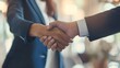 © วิรัช วนาพาพบสุข - Two men shake hands in a business setting. Concept of professionalism and trust between the two individuals