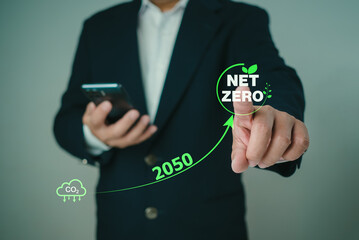 Businessman point to Net zero icon with carbon CO2 reduction for decrease within the year 2050, Carbon footprint and carbon credit to limit global warming from climate change