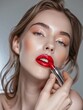 © Wiriyaporn - Woman smear her lips lipstick, Red lipstick commercial