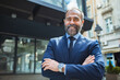 © Davor - Portrait of a confident mature businessman smiling outdoors in city