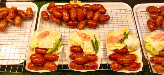 Sticker - Fried sausages on a counter in a market