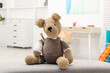 © New Africa - Toy cute bear with bandage and thermometer indoors